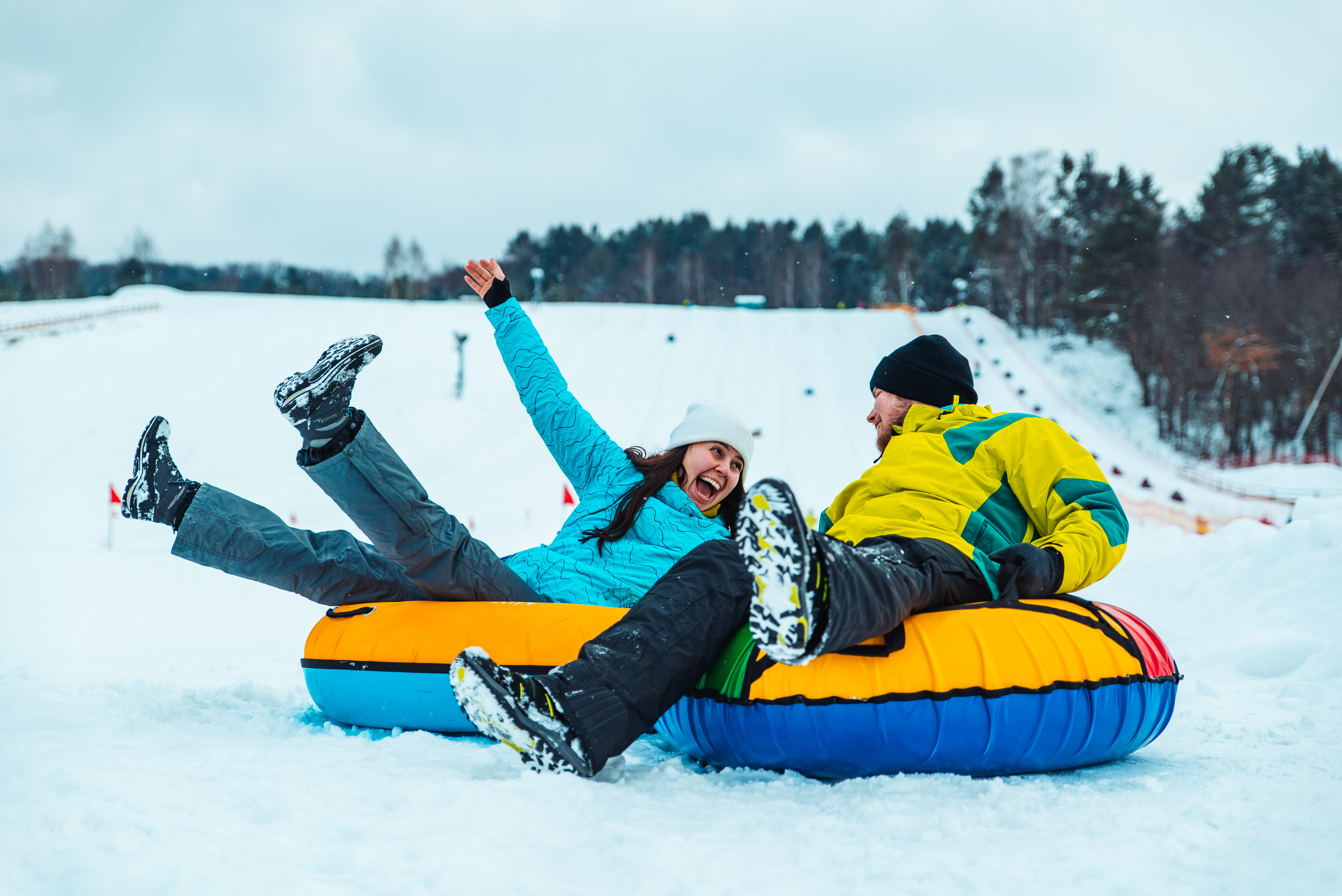 Families tubing down long illuminated lanes at Woodward Park City